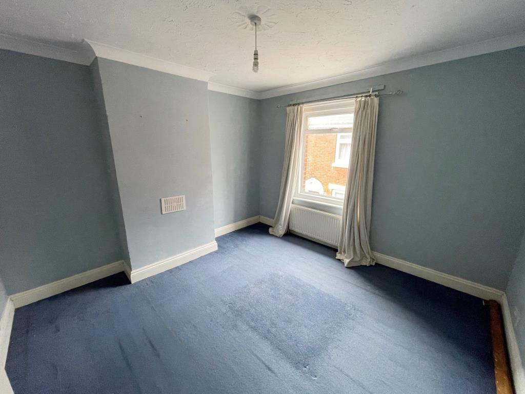 Lot: 126 - TERRACE HOUSE FOR IMPROVEMENT IN COLCHESTER CITY CENTRE - Bedroom 1 with window to front and radiator